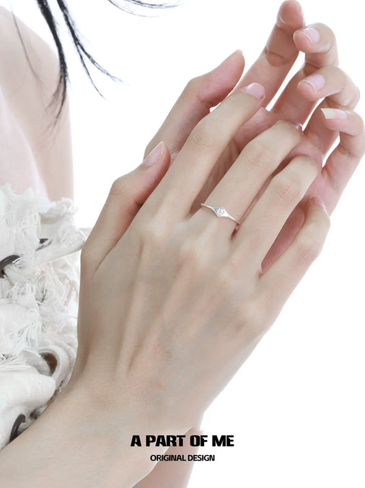 Minimalist lotus silver ring worn on a delicate hand with natural nails