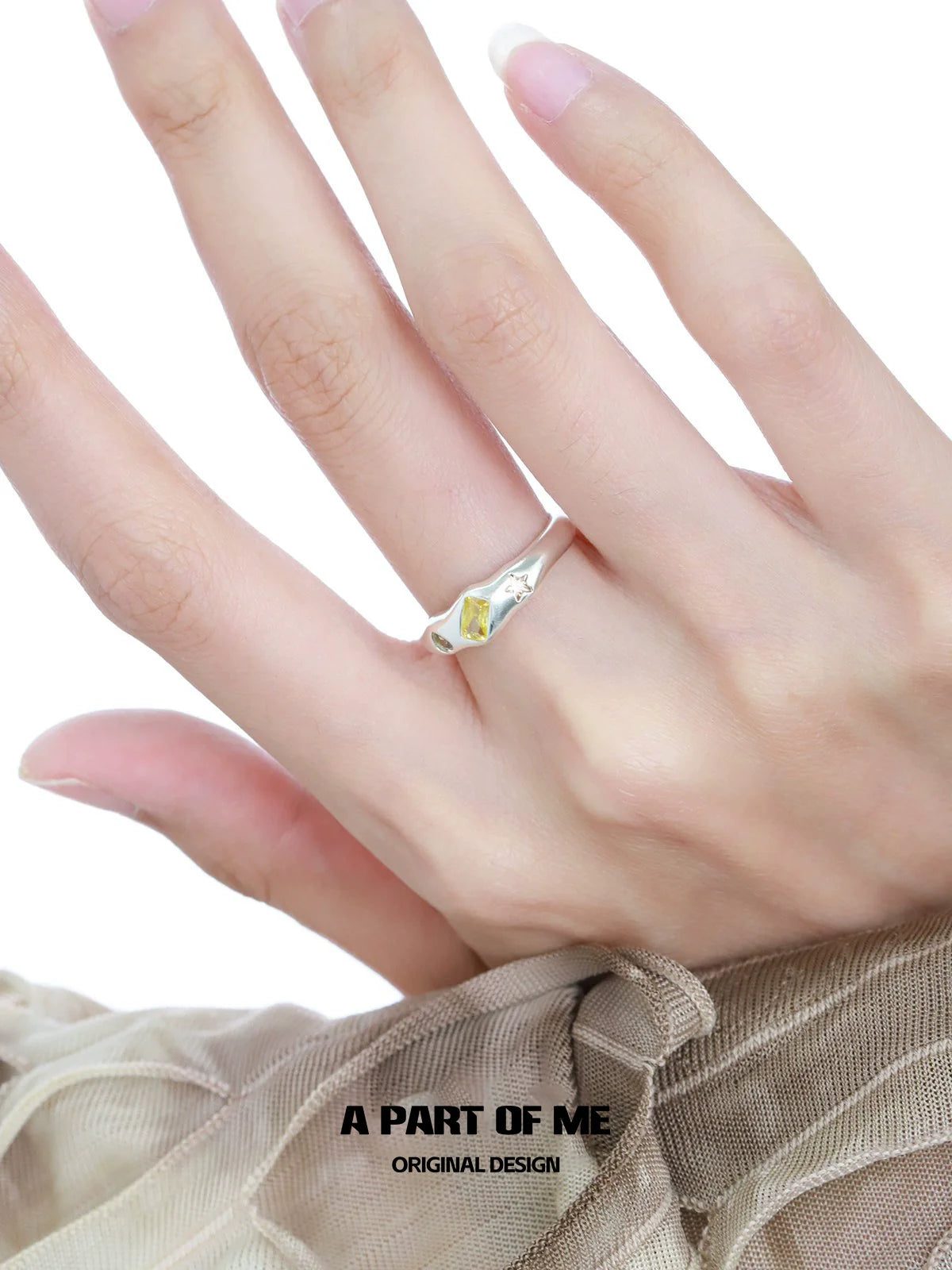 Elegant A PART OF ME rainbow star zircon ring displayed on a hand with delicate fingers