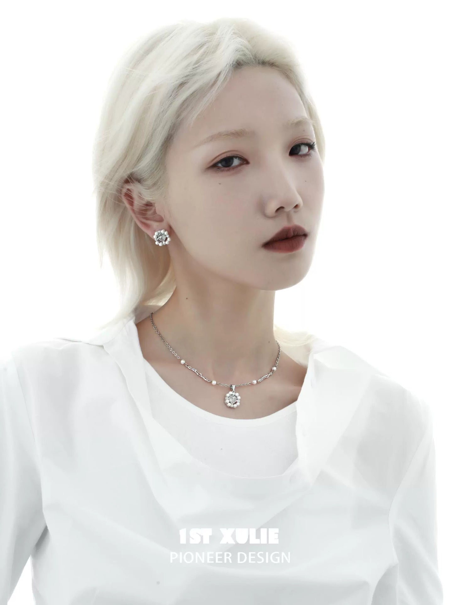 Trendy Y2K pearl earrings showcased on a model with a sleek hairstyle and minimalist outfit