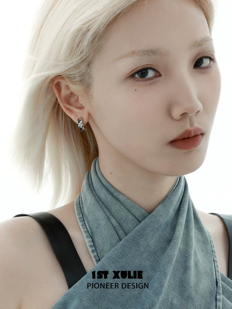 Model wearing Y2K planetary earrings showcasing a modern chic look with a soft expression