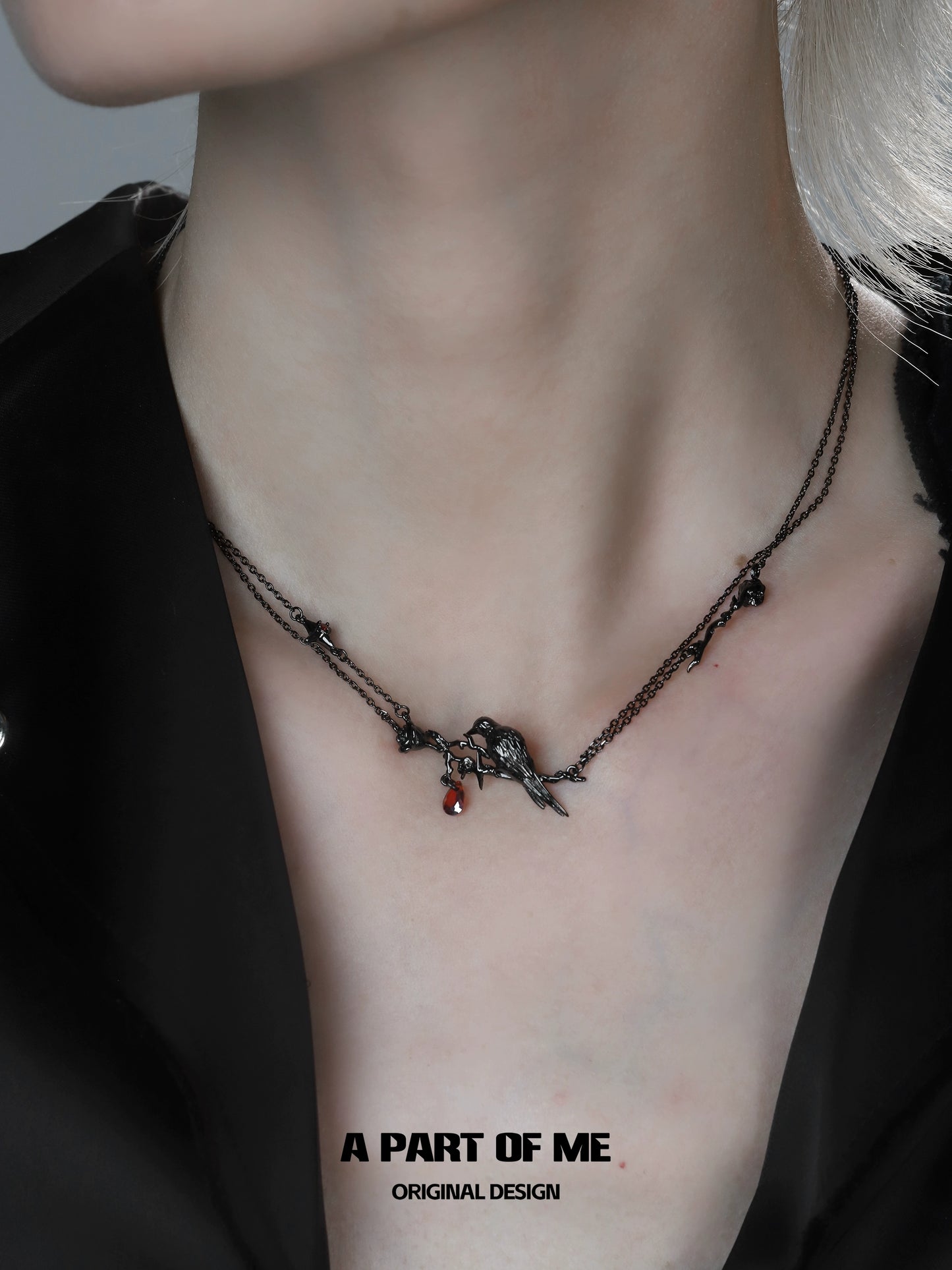 A PART OF ME Y2K raven rose necklace showcased on a model's neck with dark chains and charm details