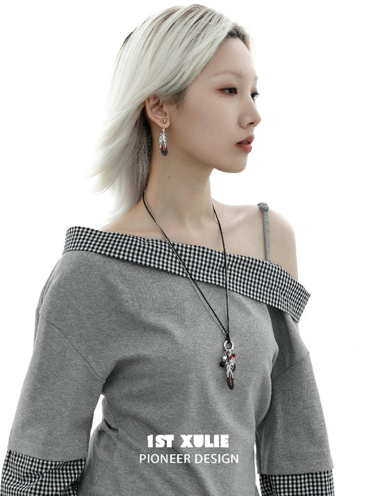 Y2K red feather earrings showcased on a model wearing a stylish gray off-shoulder top