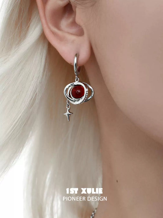 Y2K red planet earrings featuring a celestial design with a star charm on a silver-tone setting