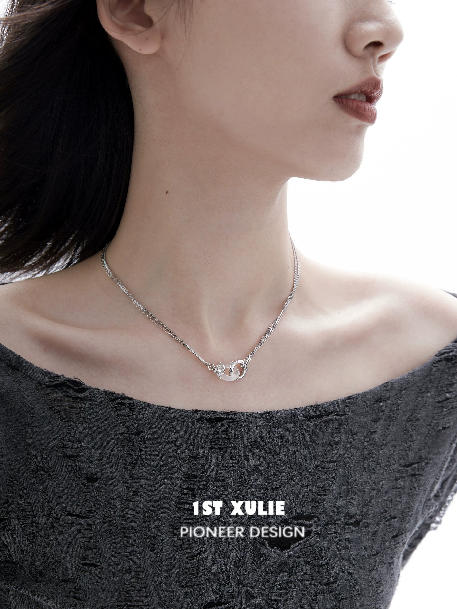 Black and white gothic necklace displayed on model with modern outfit and minimalistic design