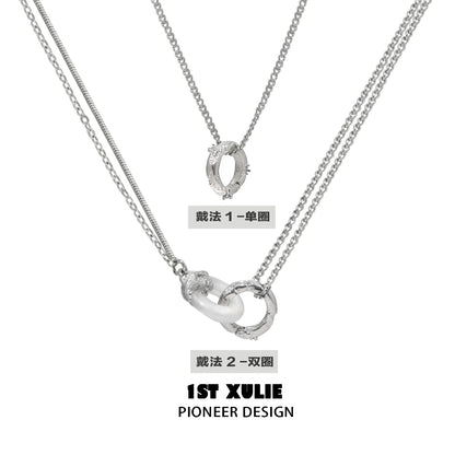 Stylish black and white gothic necklace featuring dual silver chains with unique pendant design