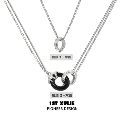 Stylish black and white gothic necklace featuring layered silver chains and unique pendants