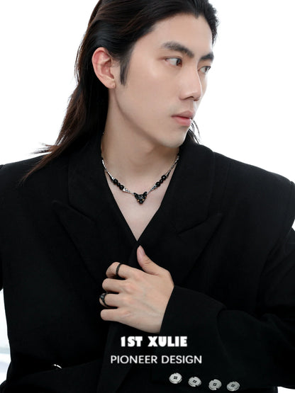 Fashionable black cat necklace featuring unique design, worn by a model in a stylish outfit