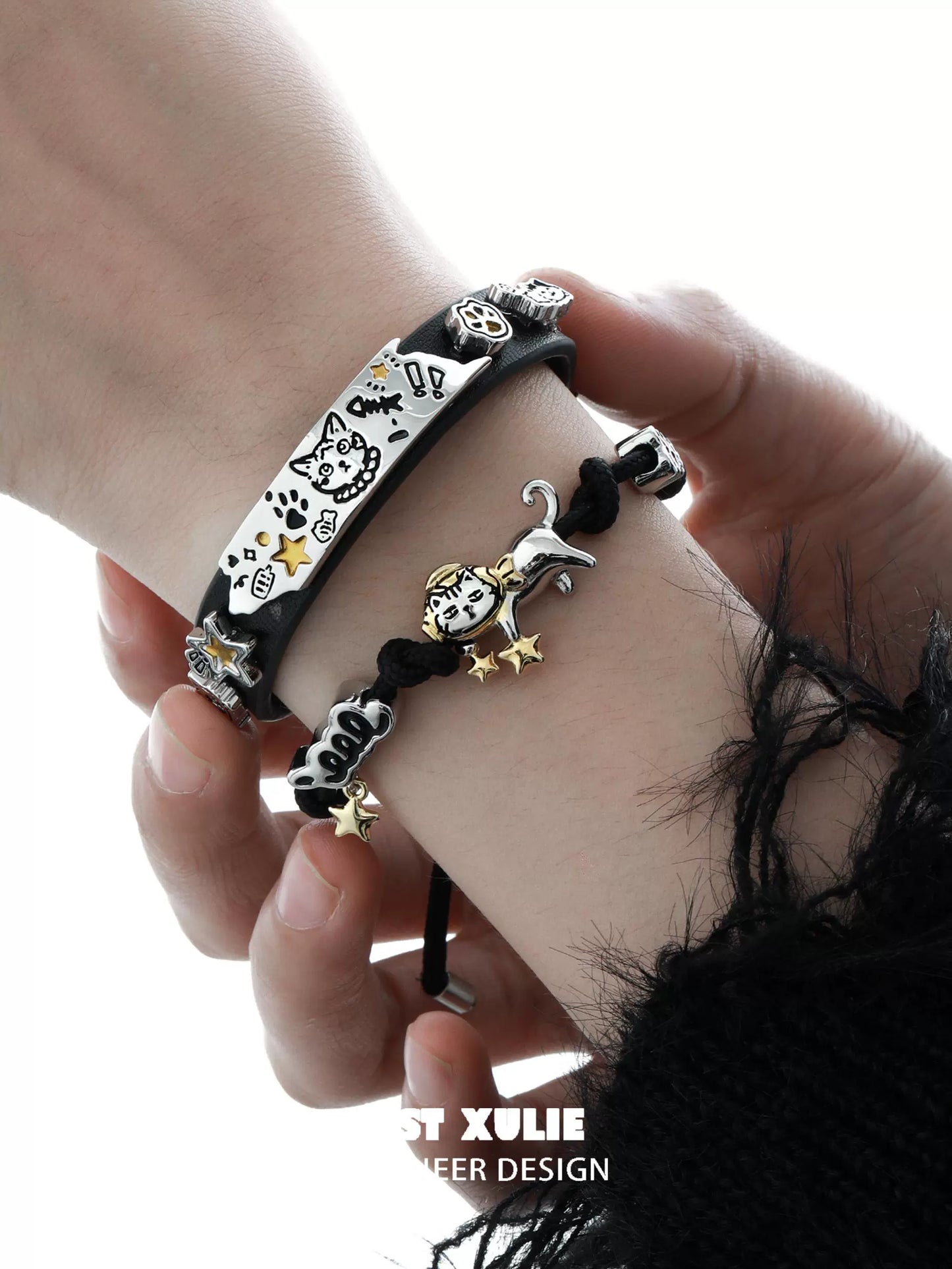 Two stylish bracelets featuring charms, including a black kitty leather bracelet for cat lovers