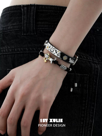 Stylish black kitty leather bracelet stacked with other bracelets for a trendy look