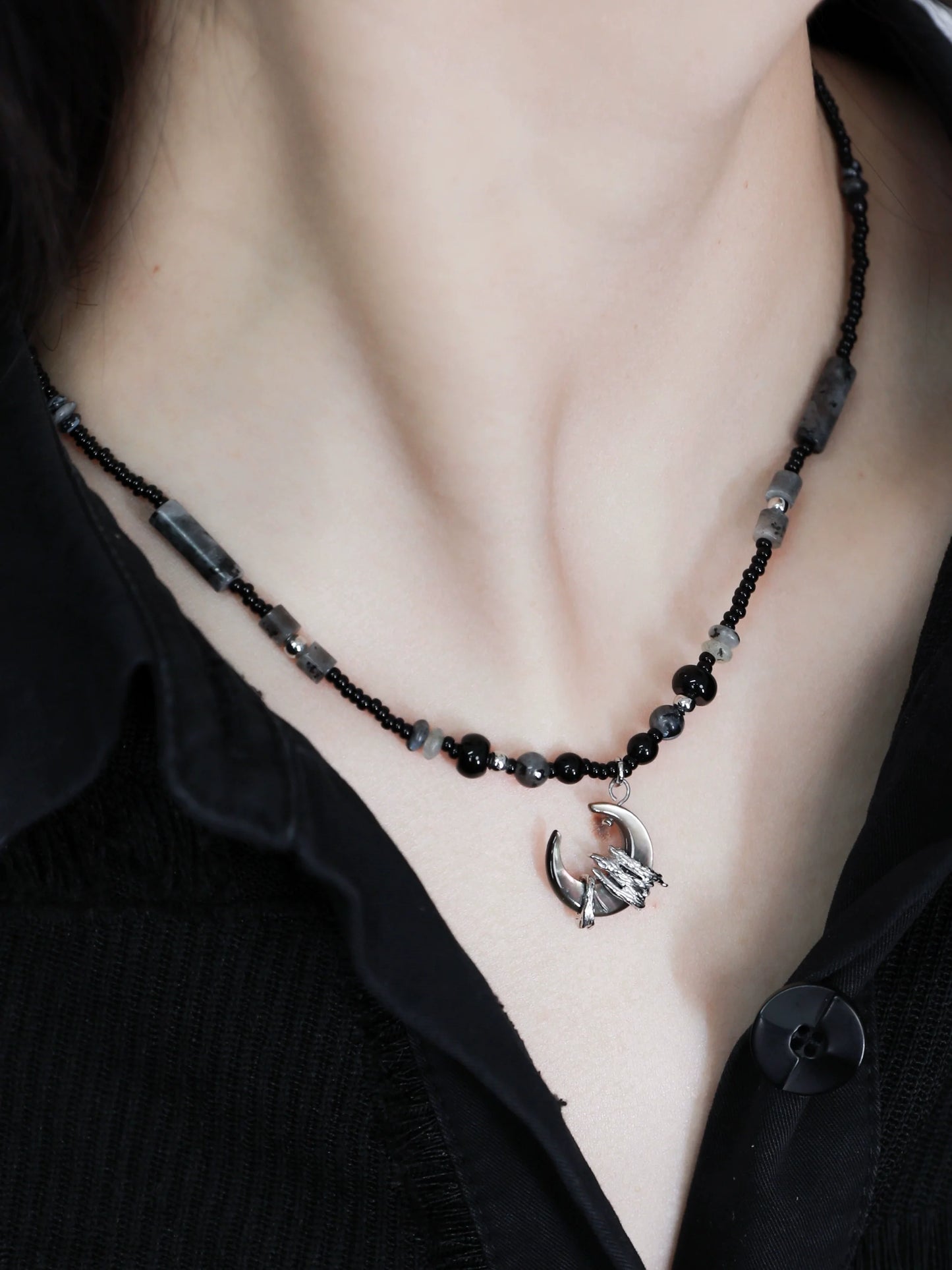 Layered black moon agate necklace with silver dragon pendant and assorted beaded design