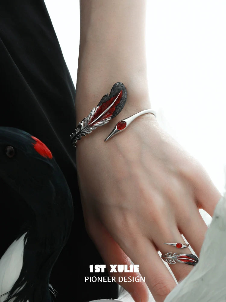 1ST XULIE Bloody Feather Bracelet with Red Accents and Intricate Design on a Hand Model