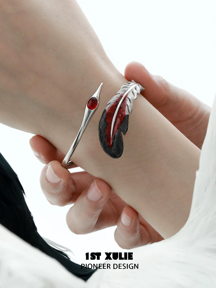 Stylish bloody feather bracelet with red gemstone and sleek metal design for a unique look