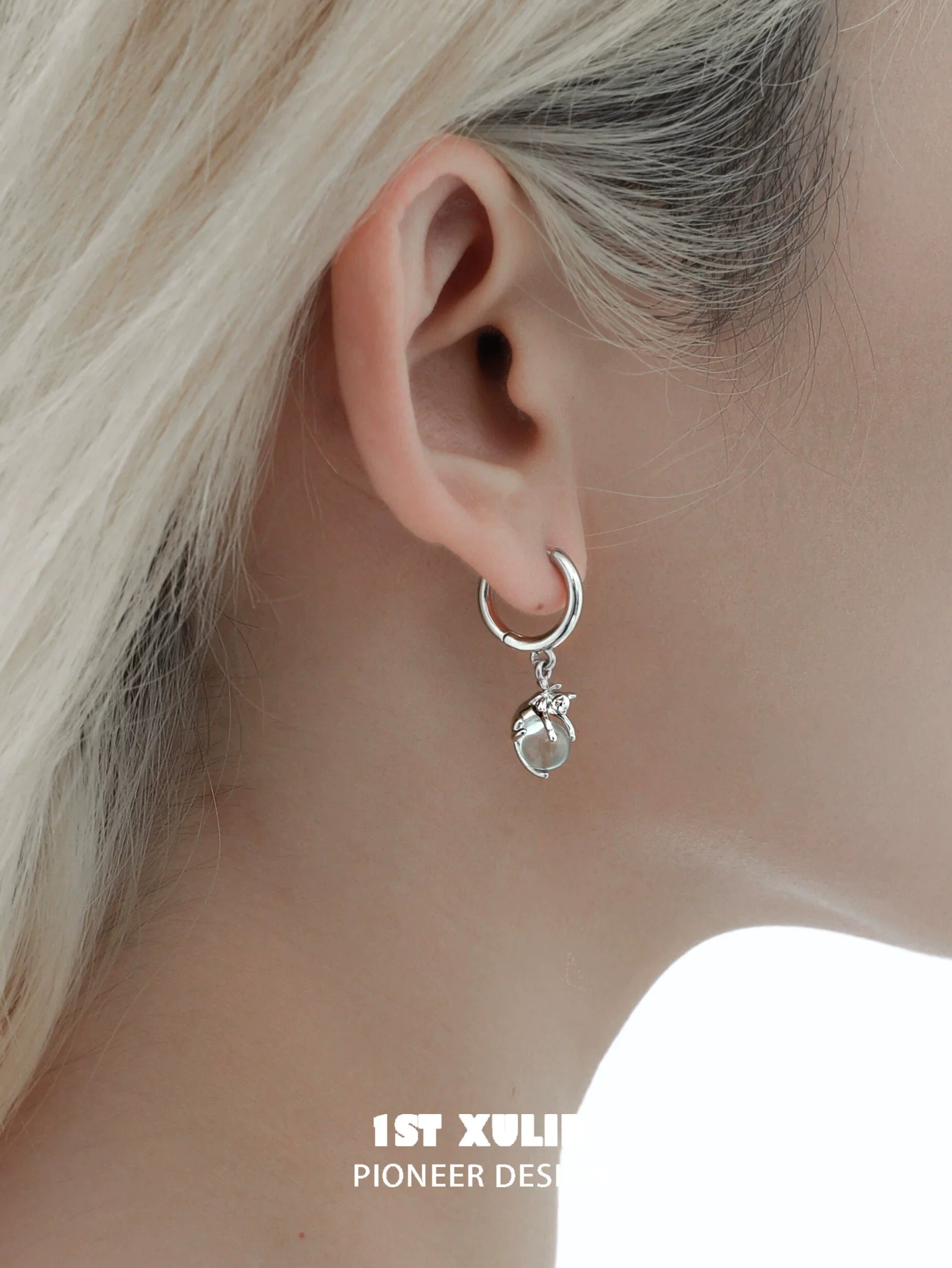 Silver hoop earrings featuring a blue kitten charm, perfect for pet lovers