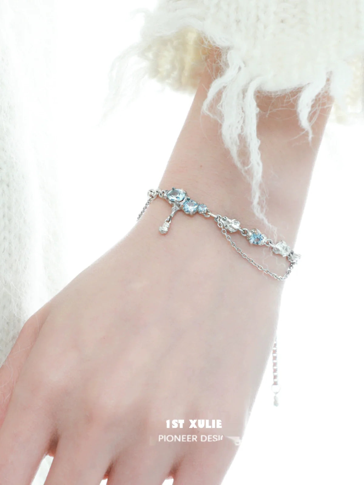 Delicate 1STXULIE blue moonstone bracelet with silver accents, elegantly worn on a wrist