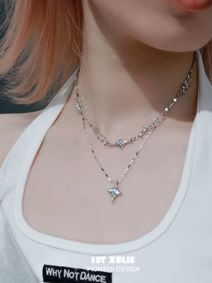 Layered silver necklaces featuring a blue starry sky necklace with sparkling star pendants