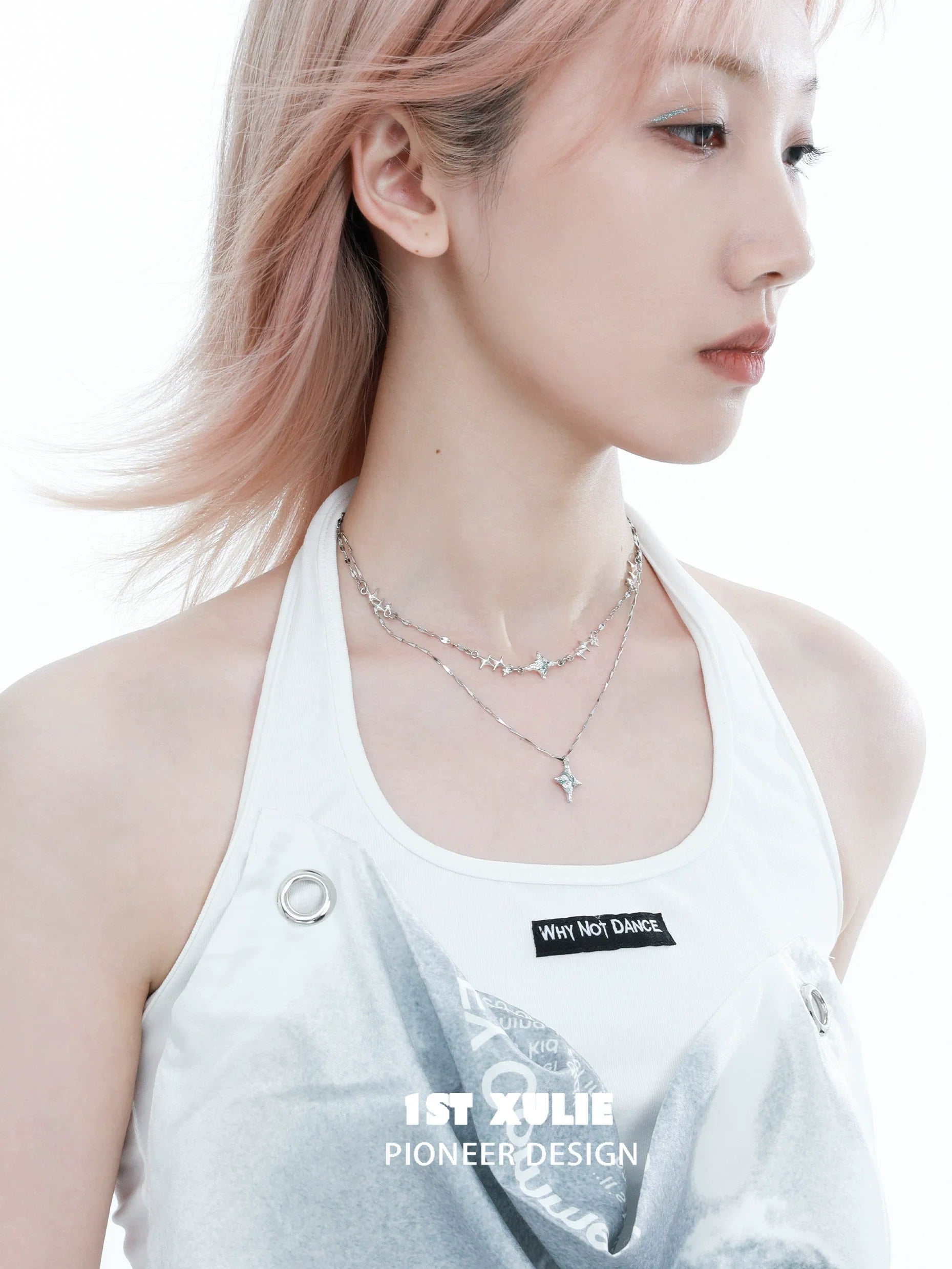 Blue starry sky necklace layered with silver chains, worn elegantly by a model
