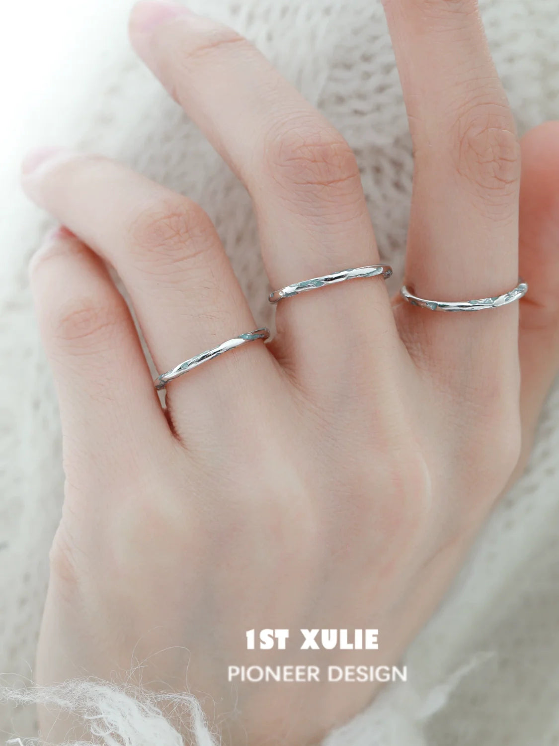 Stylish blue textured silver ring displayed on a hand with multiple rings for a trendy look