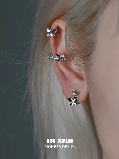 1ST XULIE butterfly silver ear cuff displayed on a model's ear for a stylish accessory look