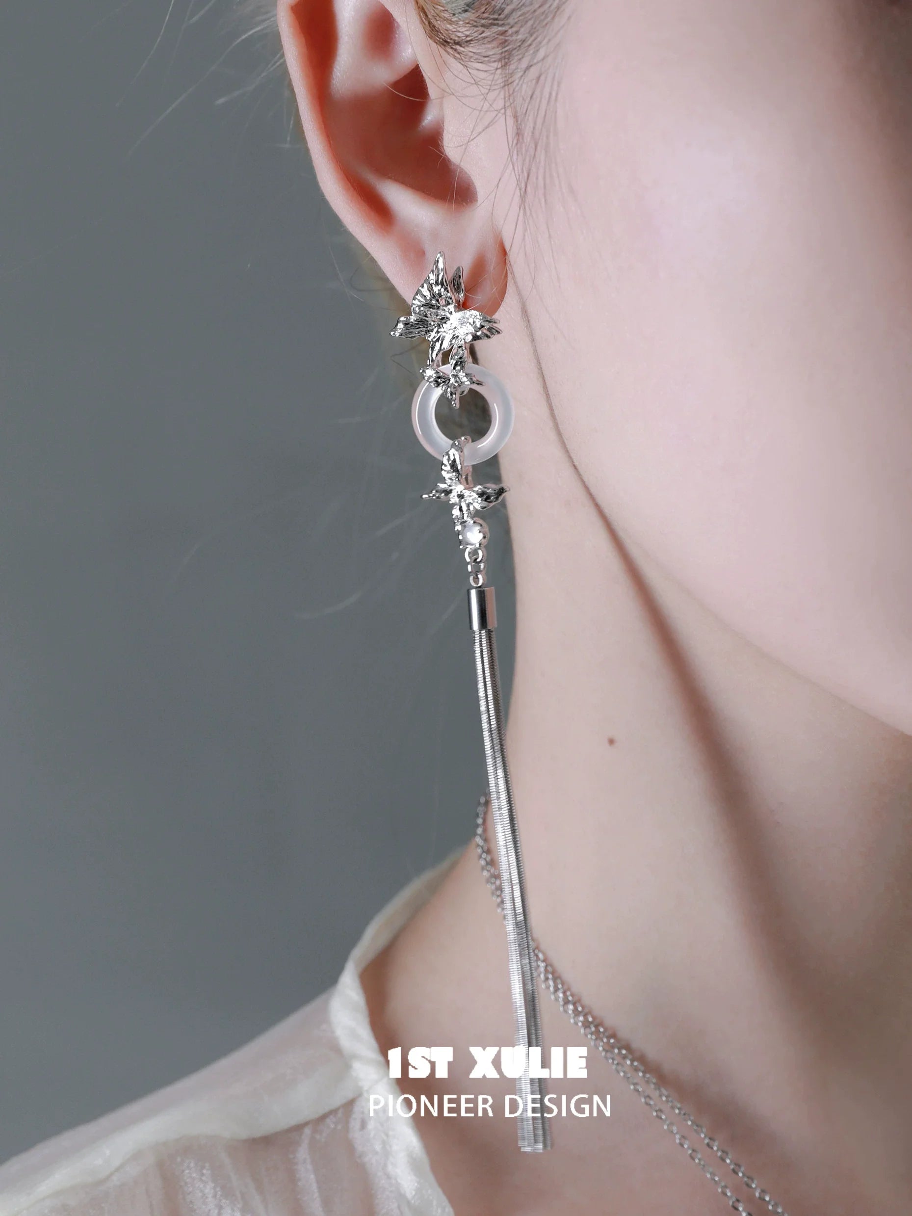 Elegant butterfly tassel earrings with silver accents and dangling design for a stylish look