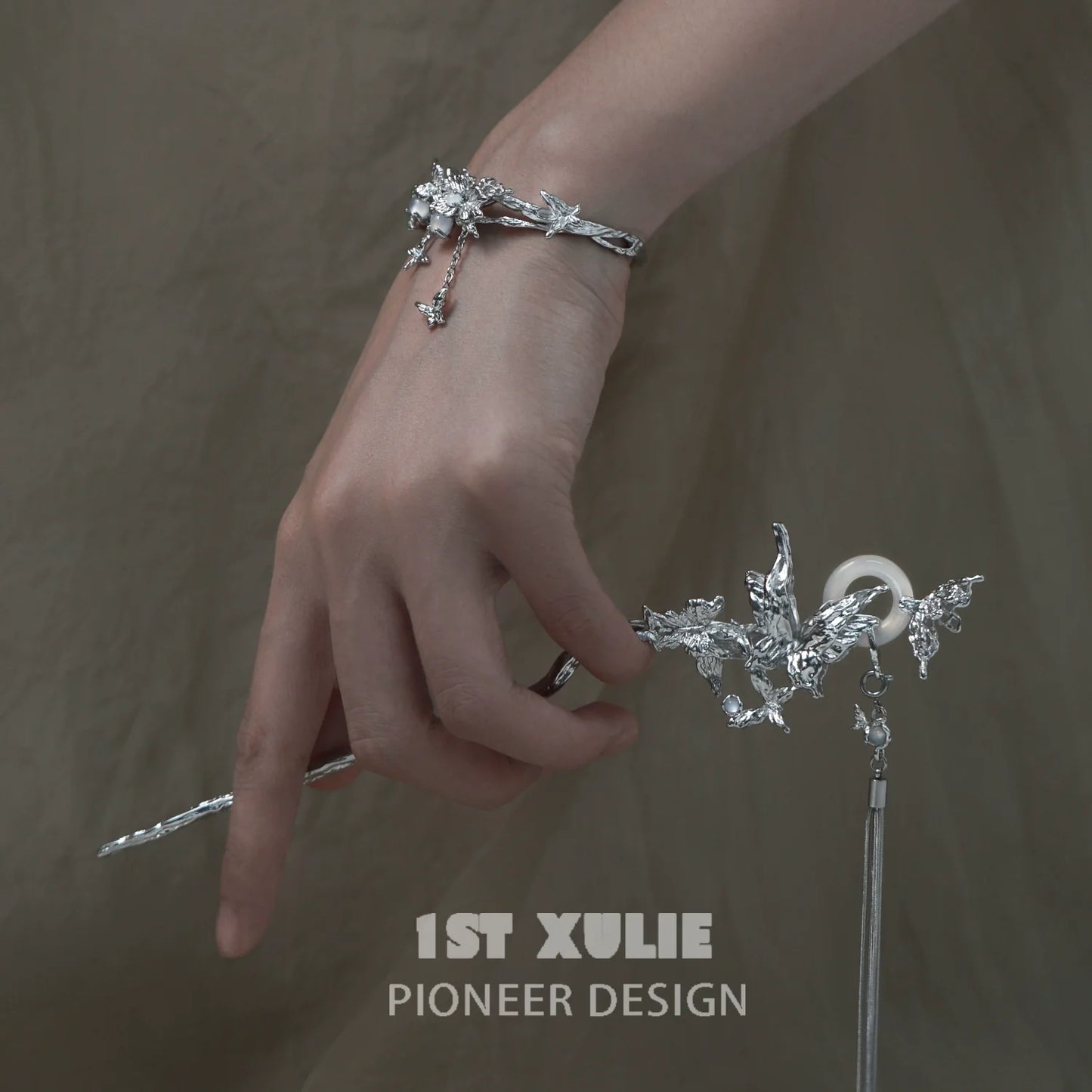 Stylish butterfly tassel white agate bracelet in silver, featuring delicate butterfly charms