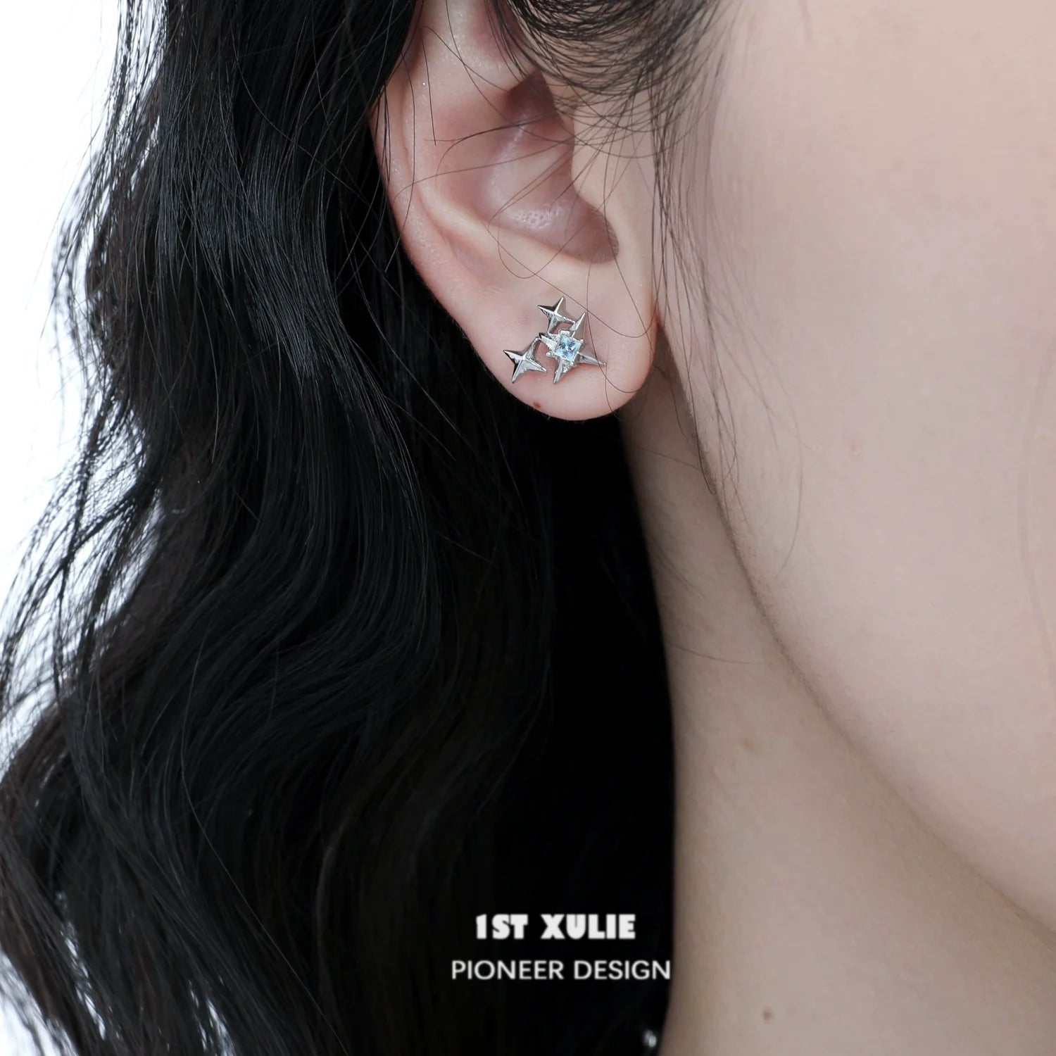 Elegant cat star stud earrings in silver showcased on a model's ear