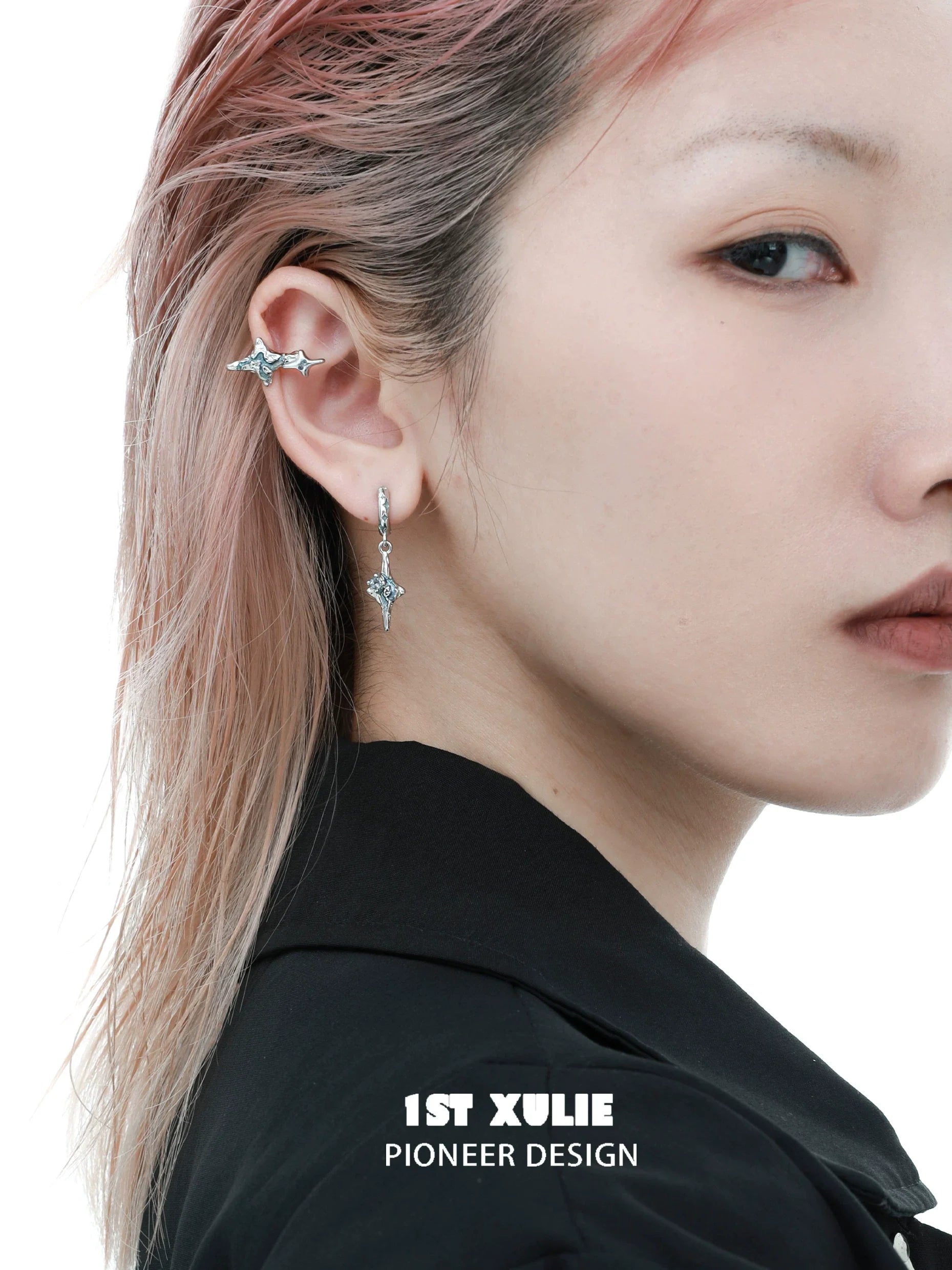 Celestial sea star earrings showcased on a model with pink hair, featuring a unique design by 1STXULIE