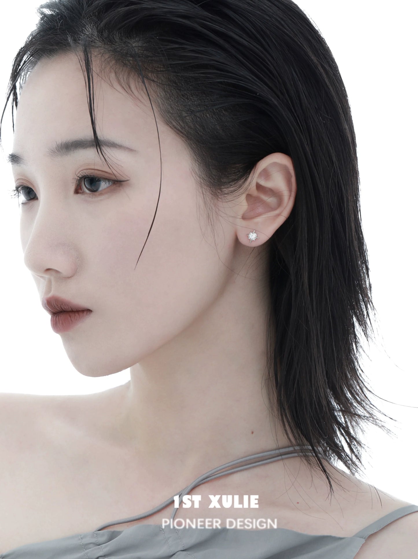 Elegant model showcasing cosmic star earrings with a minimalist design and delicate shine