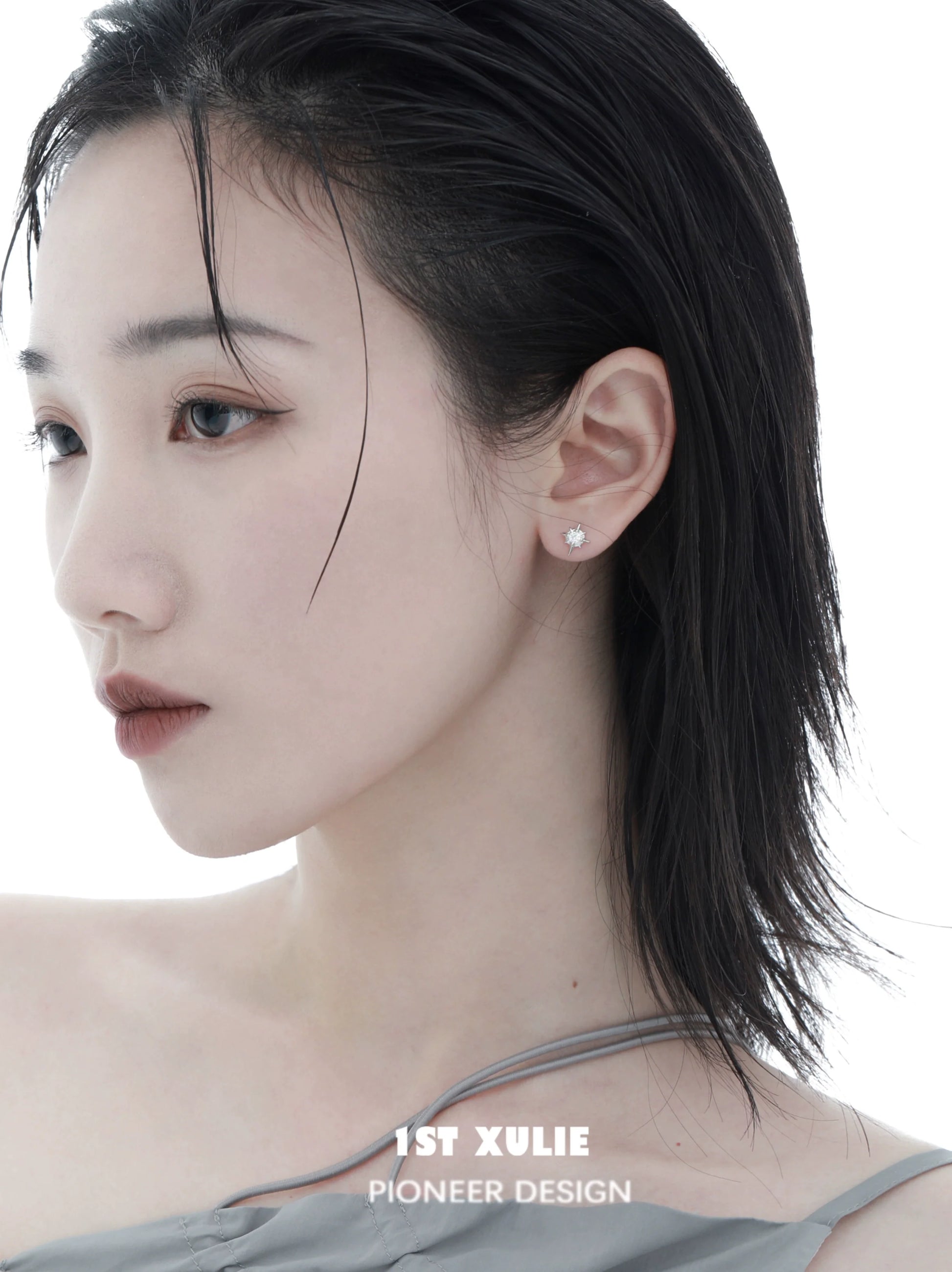 Elegant model showcasing cosmic star earrings with a minimalist design and delicate shine