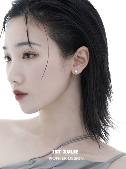 Elegant model showcasing cosmic star earrings with a minimalist design and delicate shine