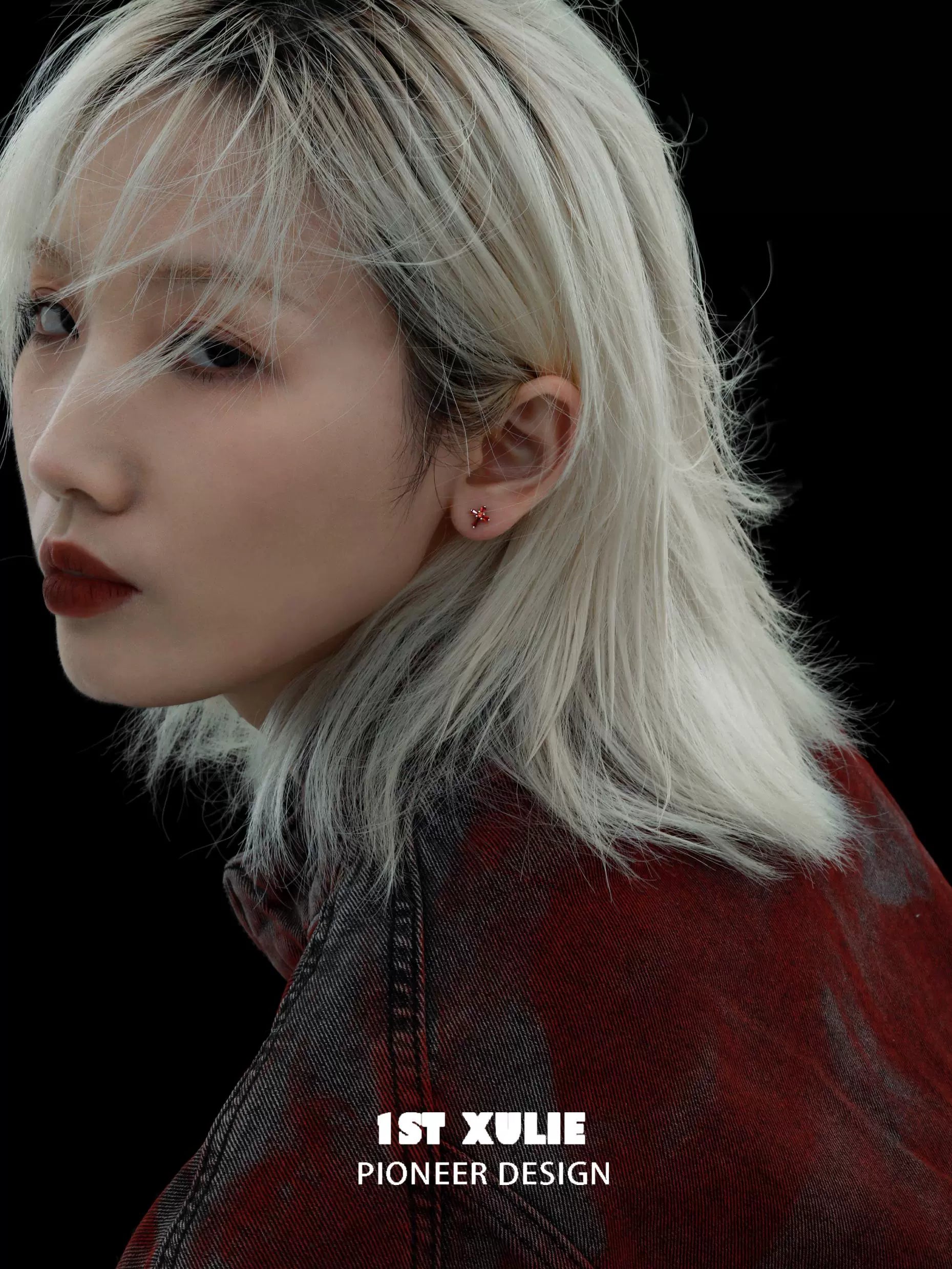 Model showcasing crimson cross gothic earrings with edgy style and sleek hairstyle