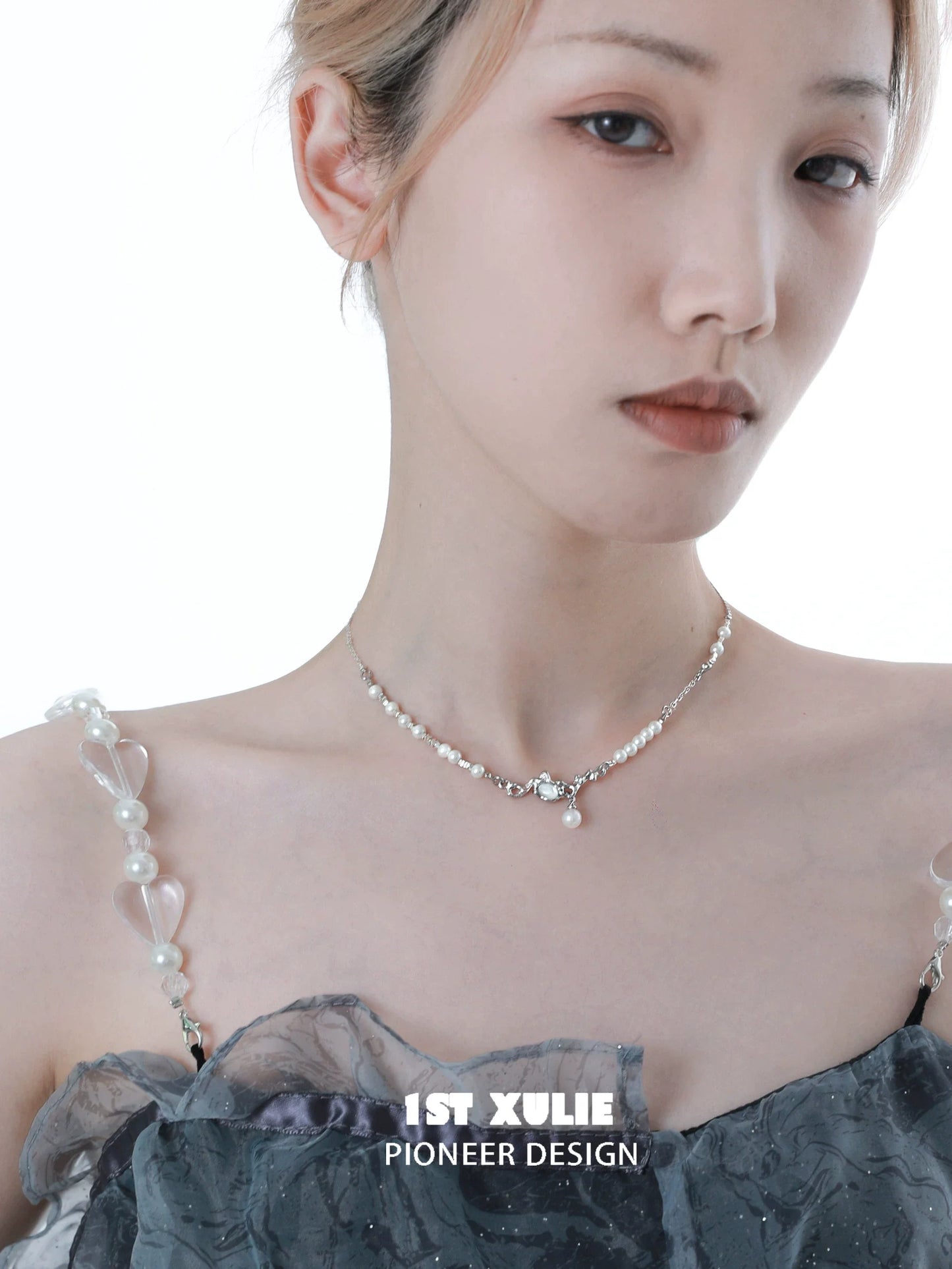 Crushed silver pearl necklace from 1ST XULIE elegantly displayed on a model with a stylish outfit