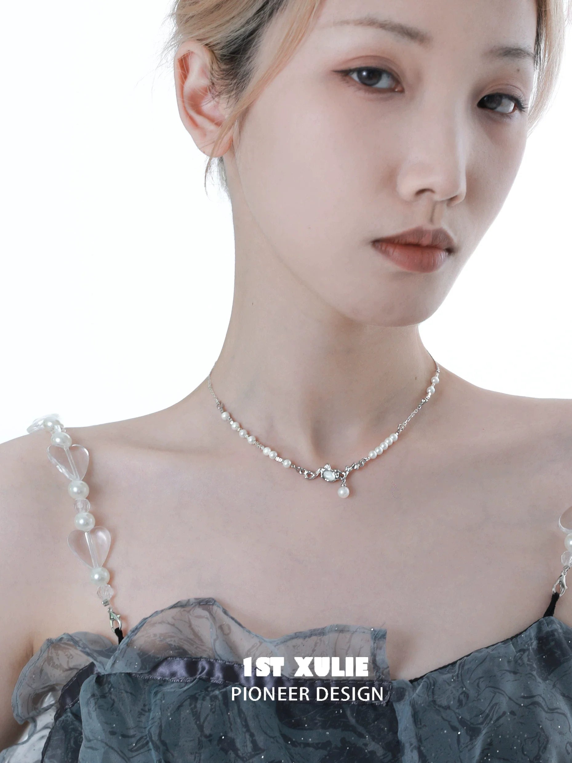 Crushed silver pearl necklace from 1ST XULIE elegantly displayed on a model with a stylish outfit