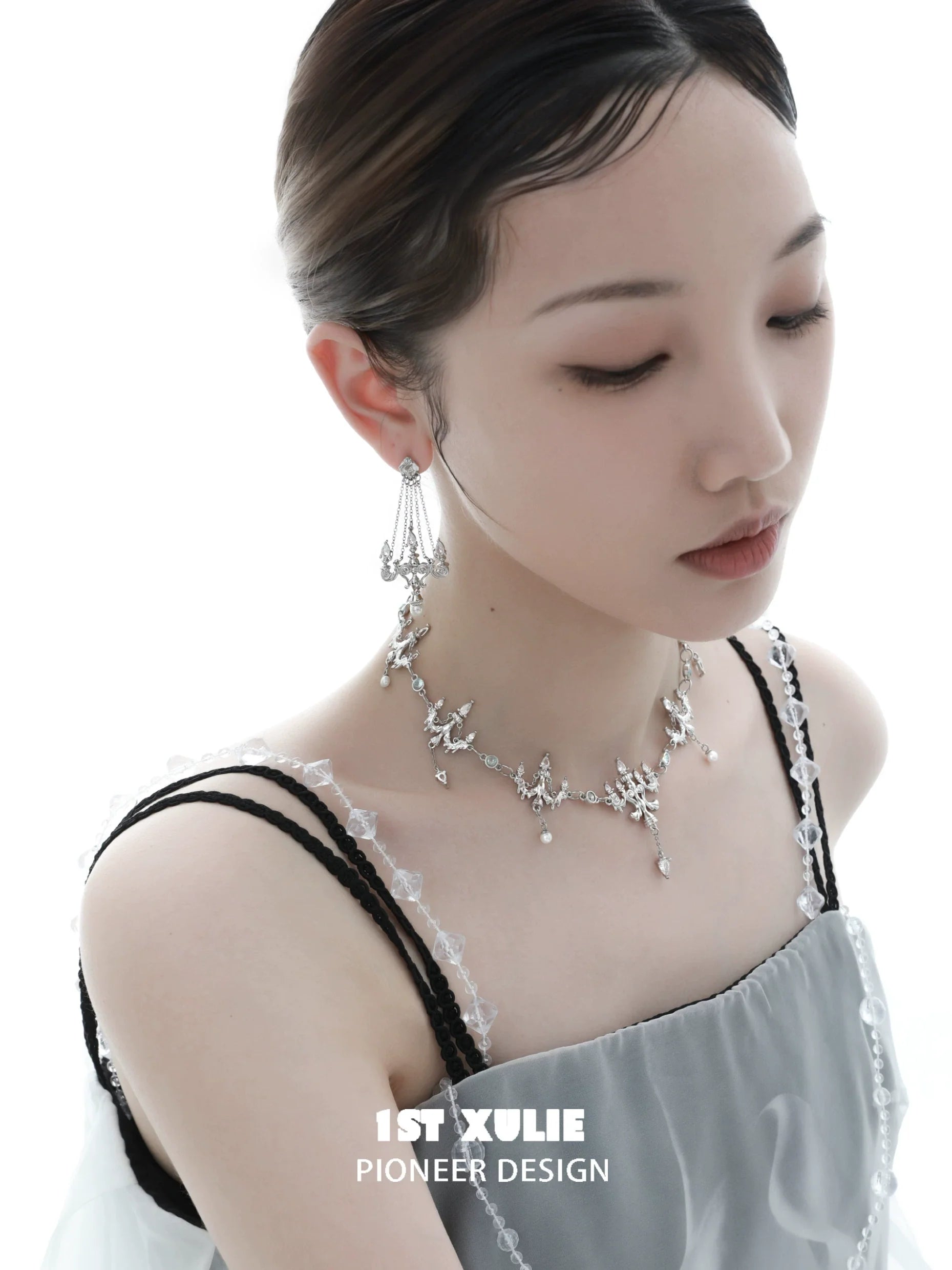 Elegant crystal lamp earrings by 1STXULIE showcased on a model, highlighting intricate design and sparkling details