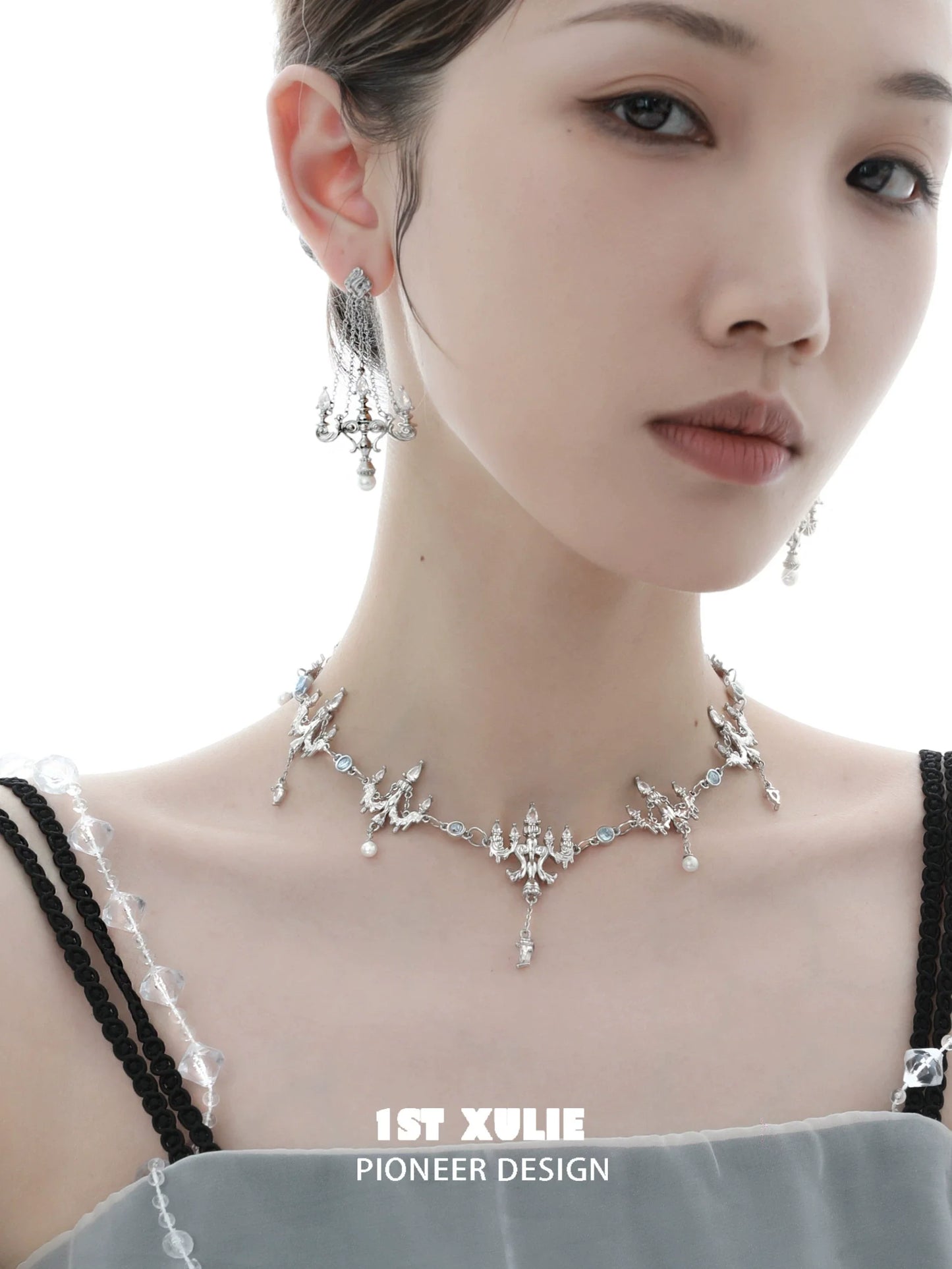Elegant model wearing crystal lamp earrings and matching jewelry from 1ST XULIE collection