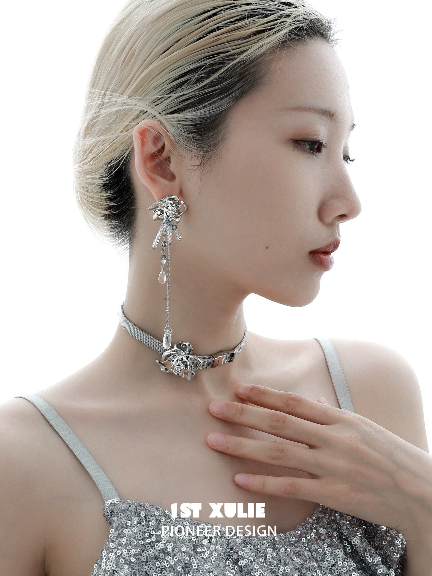 Elegant woman wearing crystal rose tassel earrings paired with a stylish choker necklace