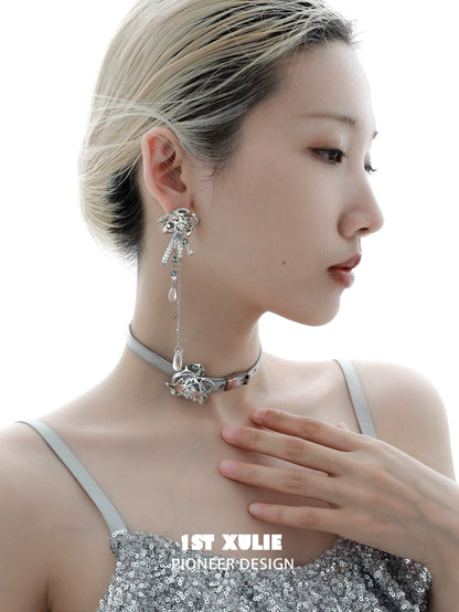 Elegant woman wearing crystal rose tassel earrings paired with a stylish choker necklace