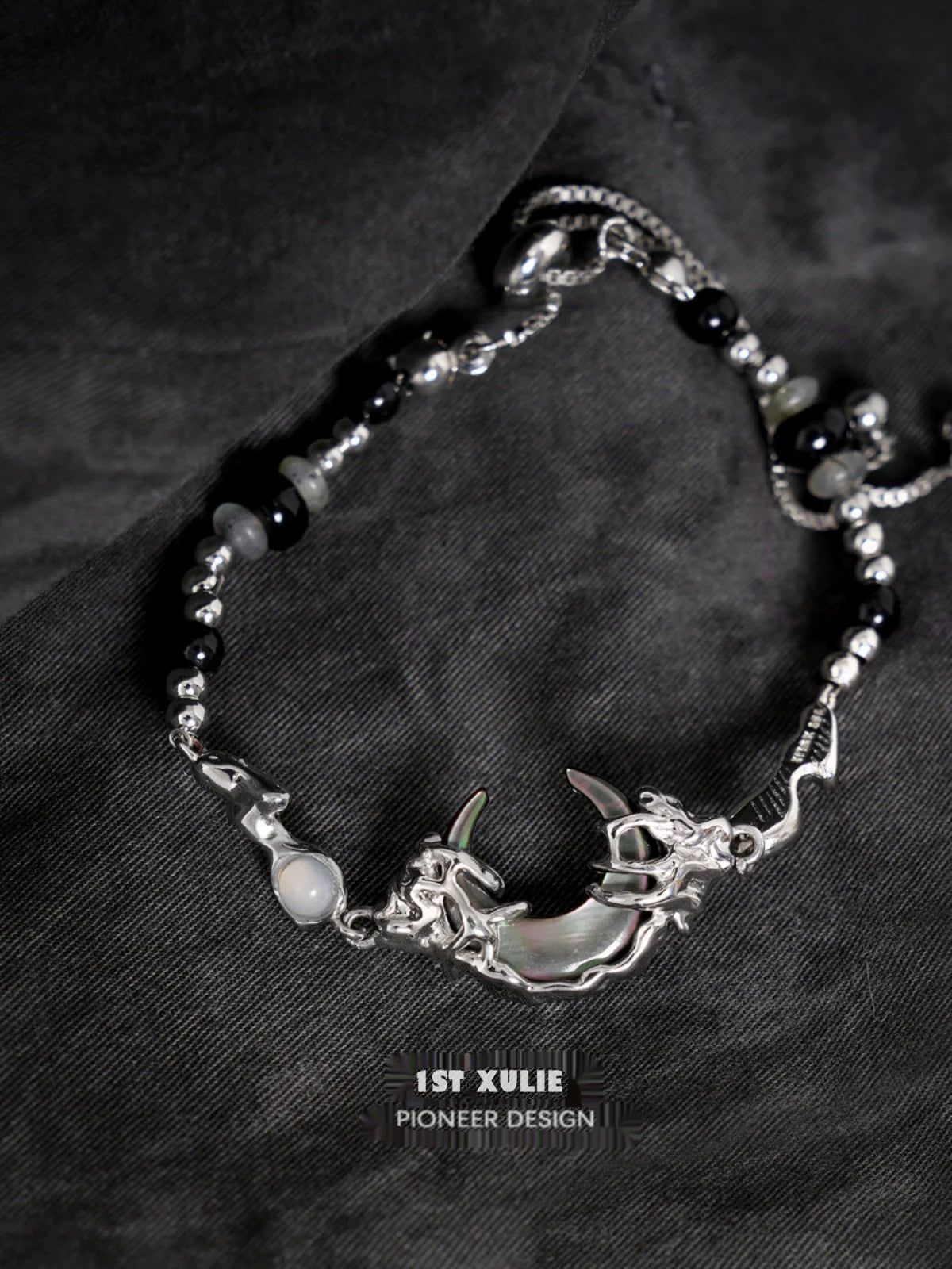 Intricate 1STXULIE dark moon agate bracelet featuring a silver moon and dragon design