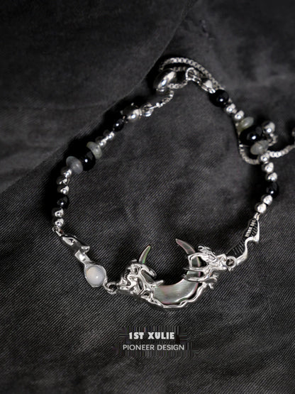 Intricate 1STXULIE dark moon agate bracelet featuring a silver moon and dragon design