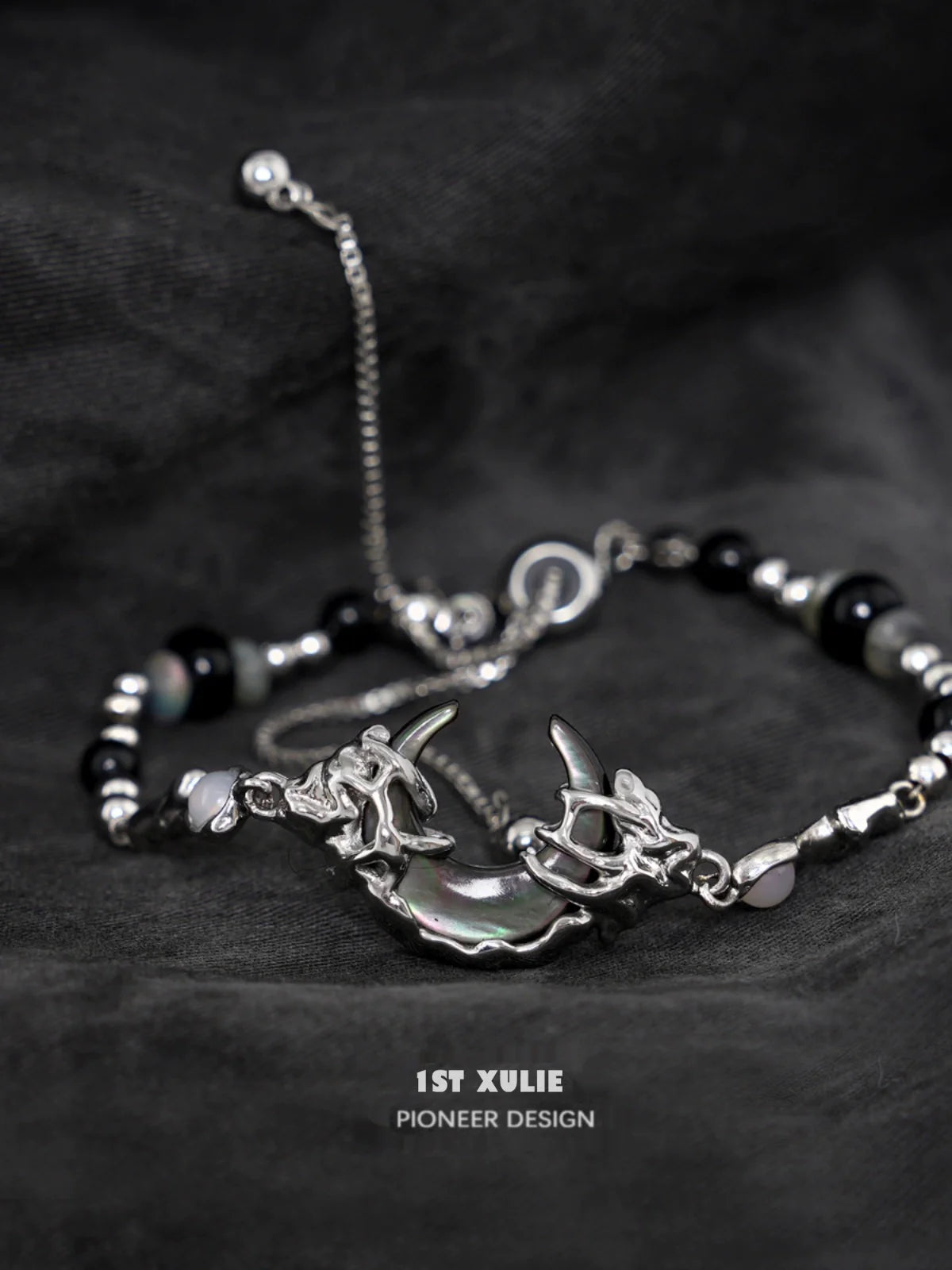 Stylish dark moon agate bracelet with silver accents and unique charm design for modern jewelry lovers