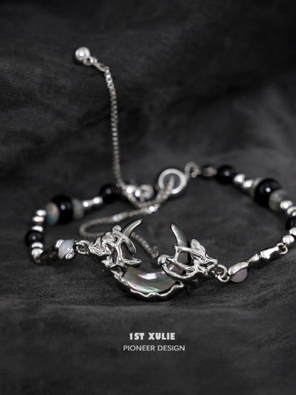 Stylish dark moon agate bracelet with silver accents and unique charm design for modern jewelry lovers