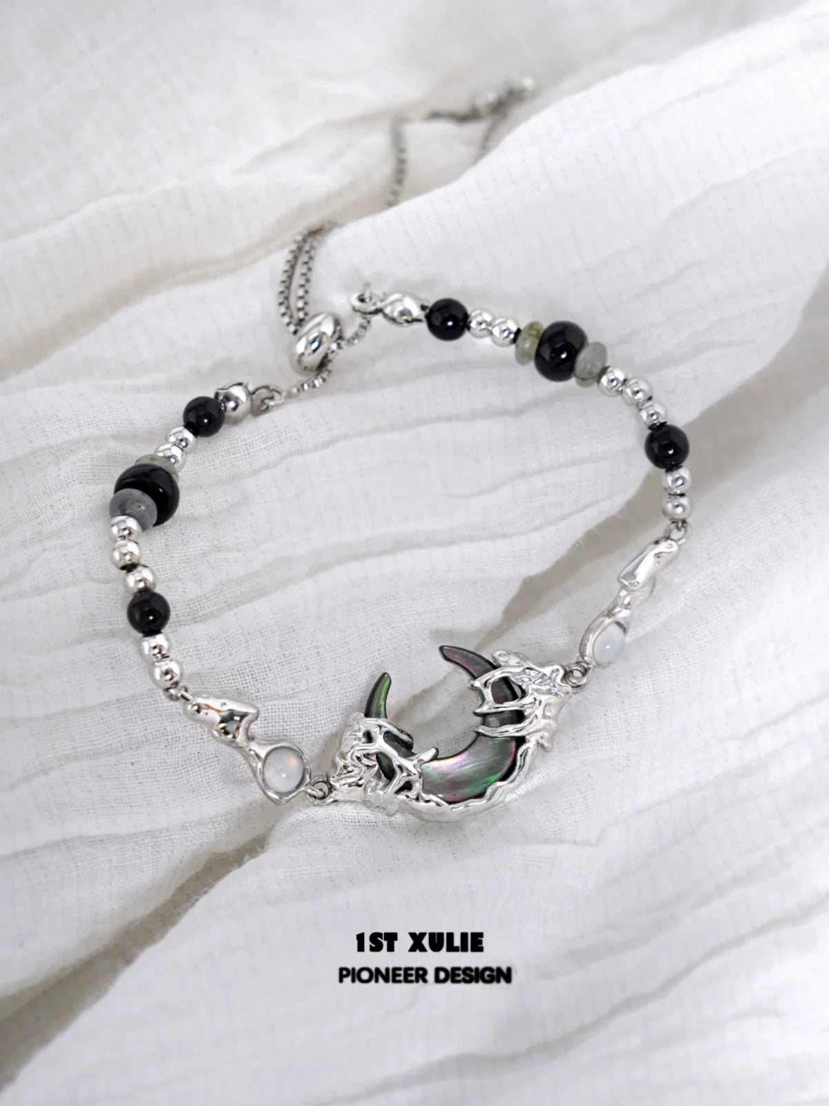 Dark moon agate bracelet with silver accents and intricate detailing for unique style