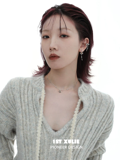 Stylish model wearing a desert planet necklace with unique design elements and modern fashion attire