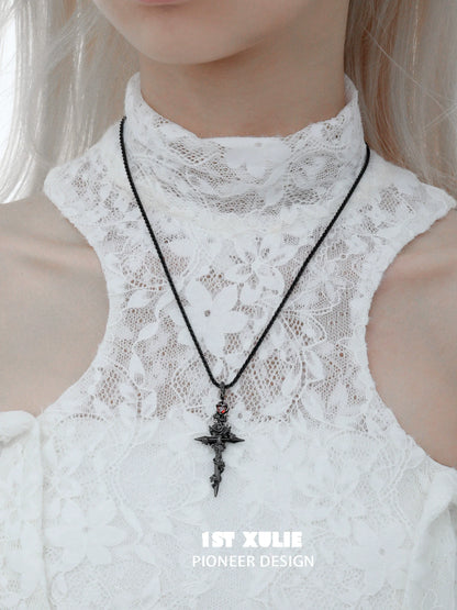 Diablo rose cross necklace in silver with intricate detailing, worn on a lace top