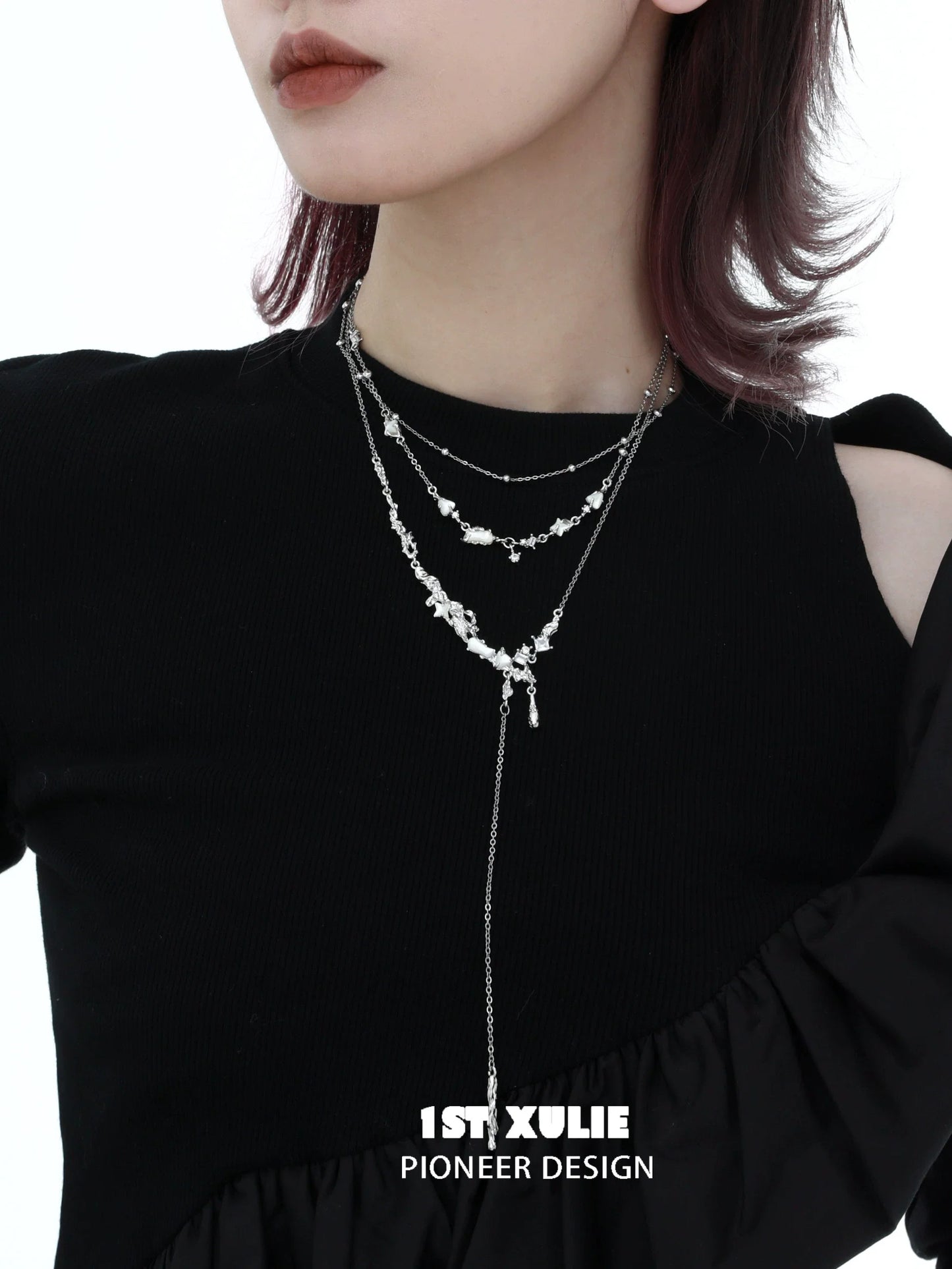 Stylish model wearing a double layer moon necklace with delicate silver chains and decorative charms