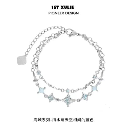Double layer starfish silver bracelet featuring shimmering blue accents and a delicate chain design