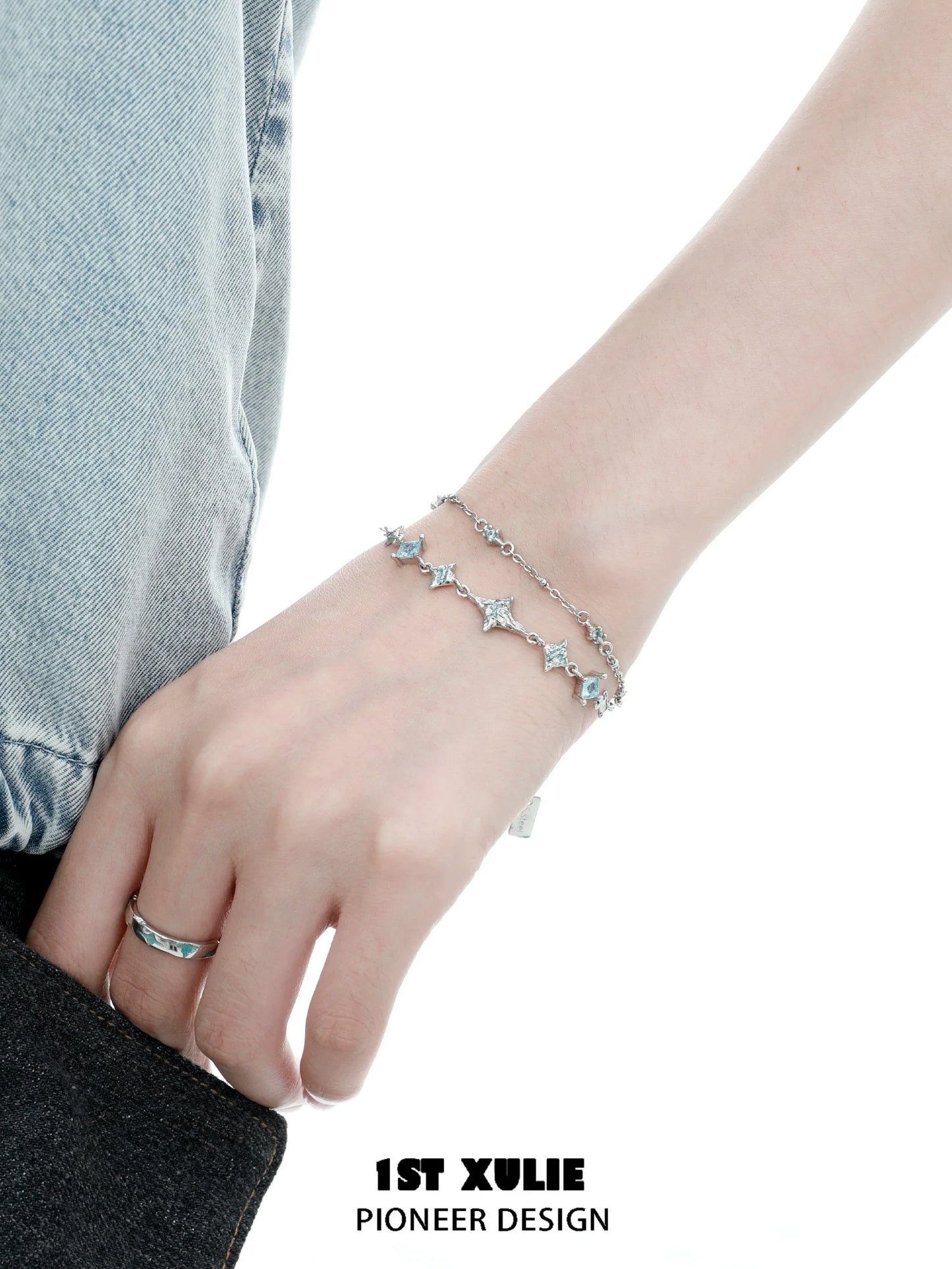 Double layer starfish silver bracelet with sparkling details worn on a wrist