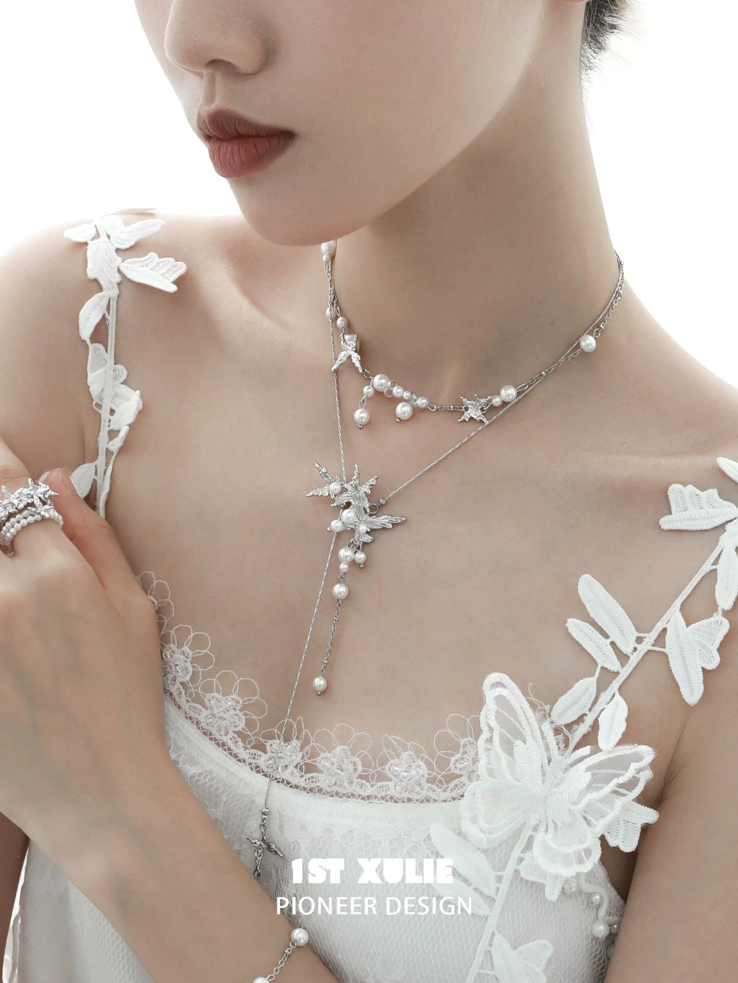Elegant model wearing a dream wings pearl necklace featuring silver and pearl accents, perfect for special occasions
