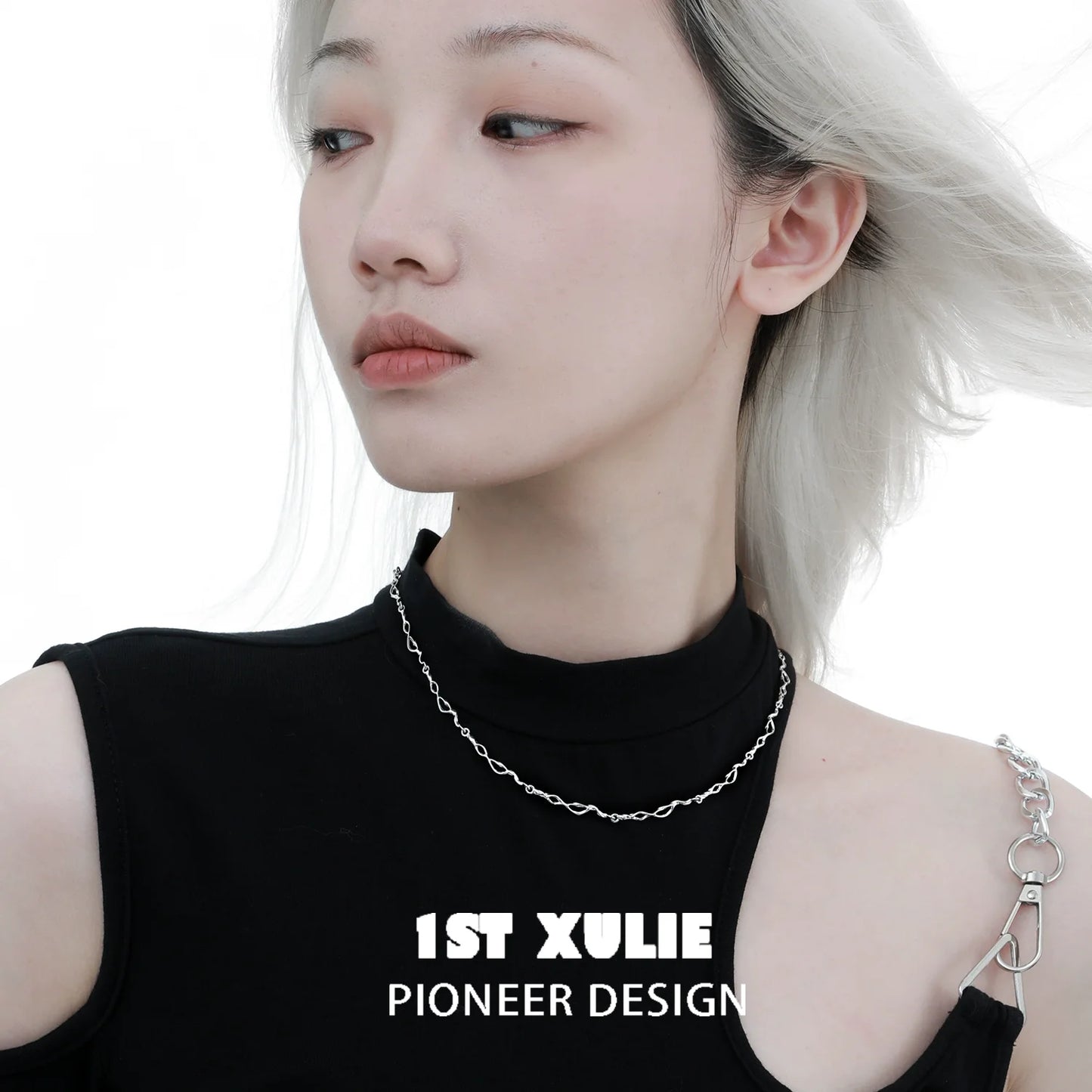 Edgy chain necklace modeled by a person wearing a black top highlighting modern fashion design