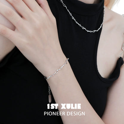 1ST XULIE Edgy chain necklace in silver paired with matching bracelet on a model's arm