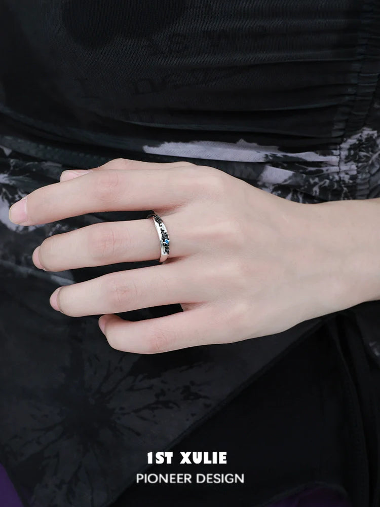 Stylish hand wearing eroded earth couple rings designed by 1STXULIE for modern couples